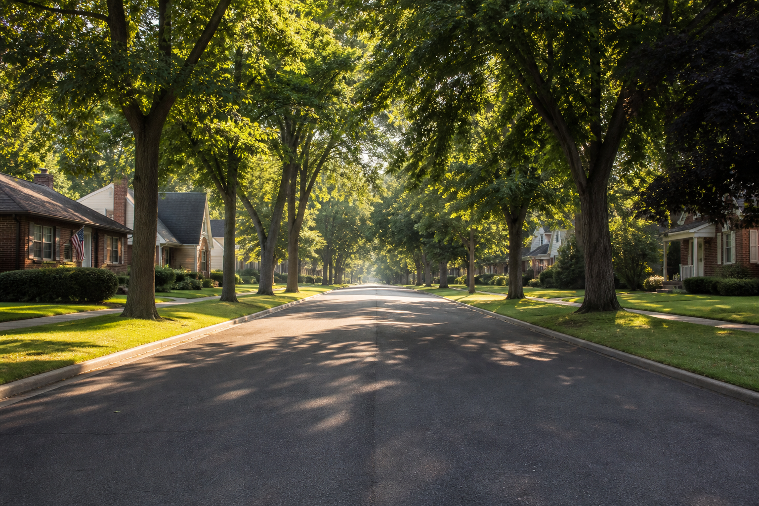 Tree-lined residential street in Independence, Missouri on a summer morning